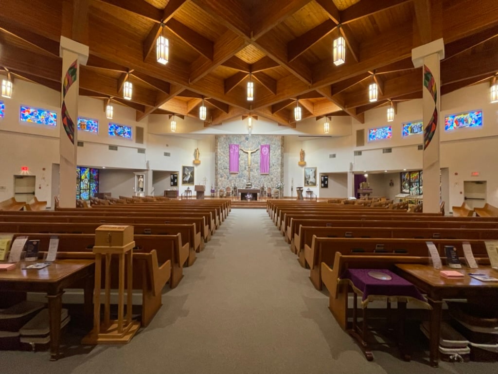 This image displays St John Vianney Church adorned with Banners for Advent