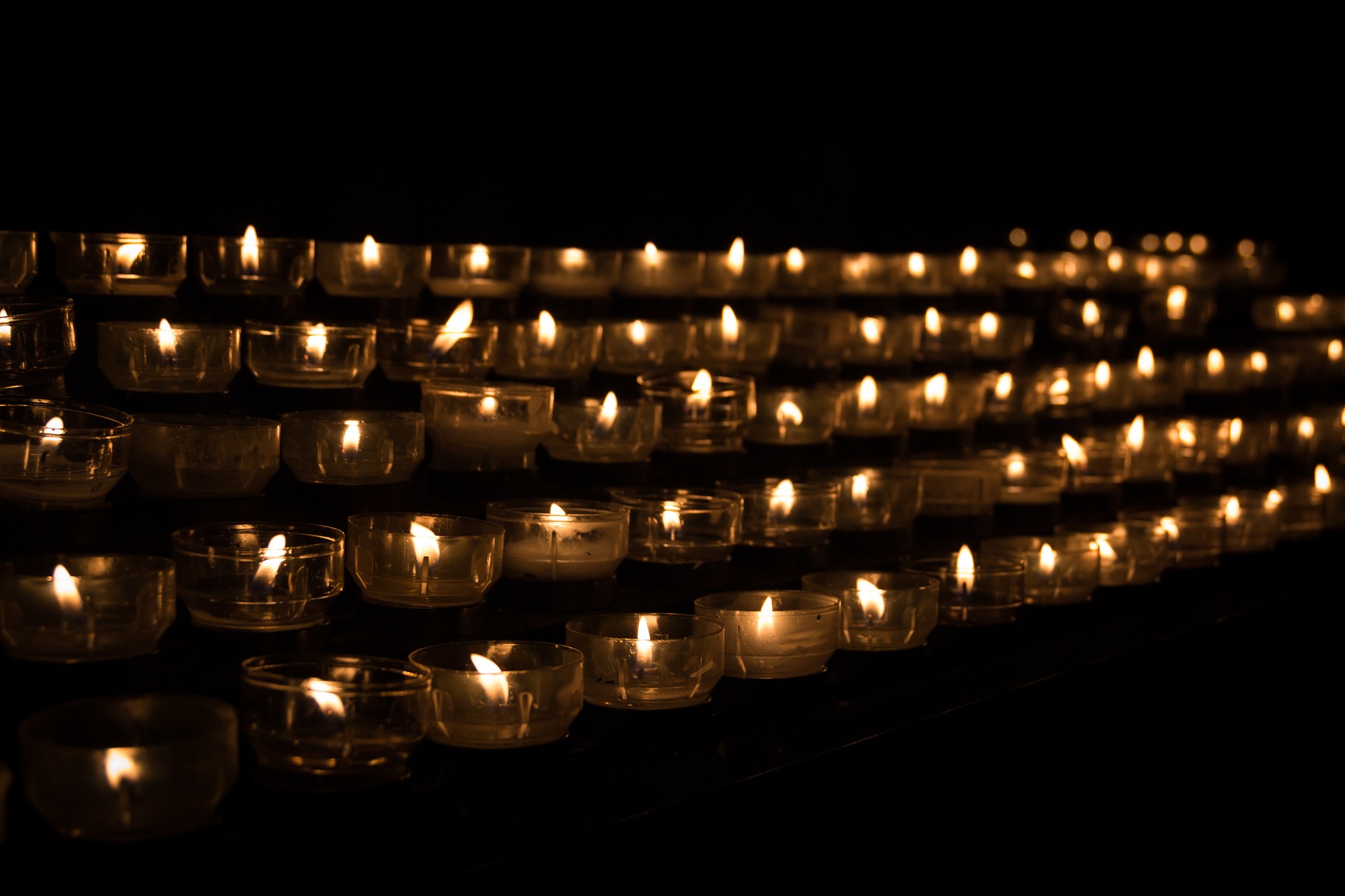 This image displays candles lit on a dark background.