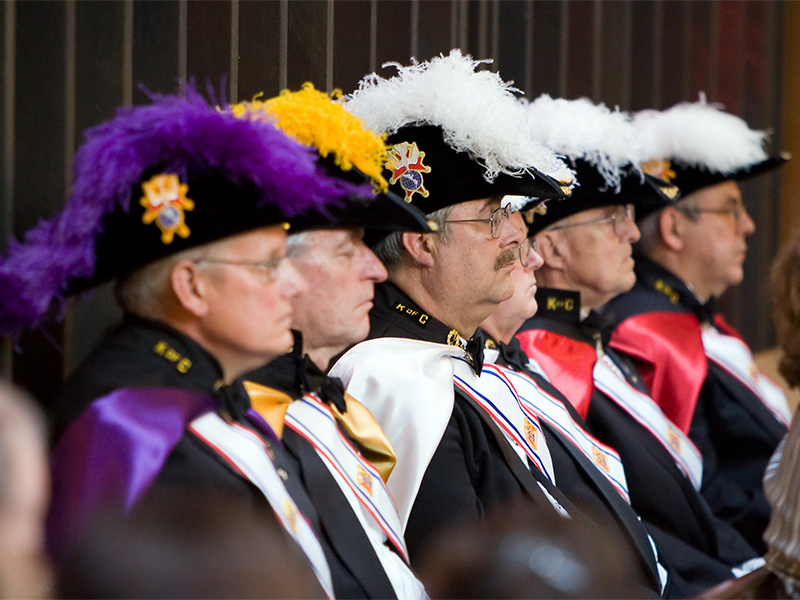 This image shows five men in ceremonial attire of the Knights of Columbus